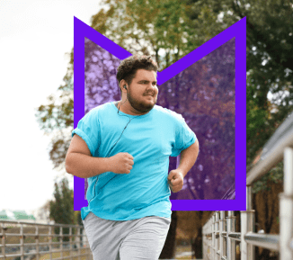 A young man running across a bridge while he listens to music